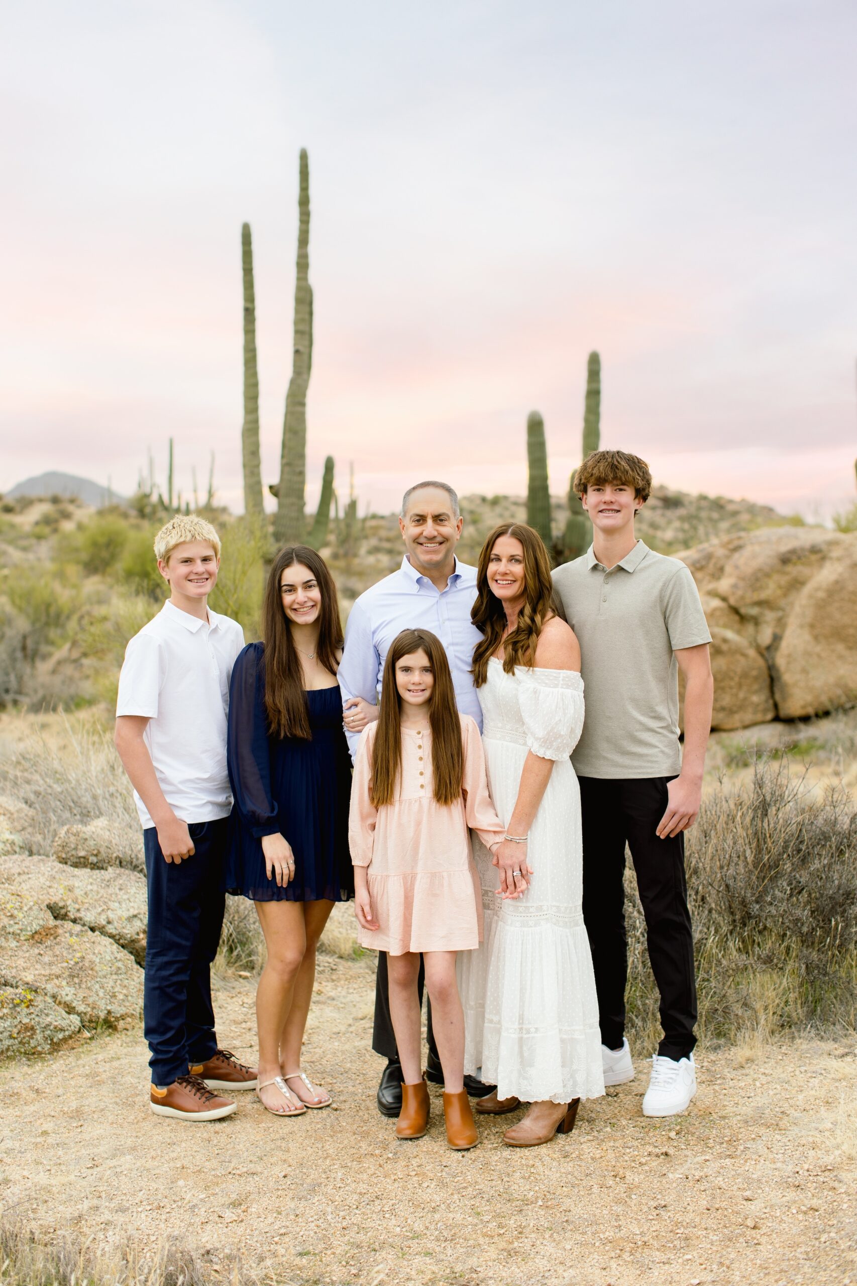 Family of 6 in the Arizona desert during golden hour. Mom, Dad, two girls, and two boys.