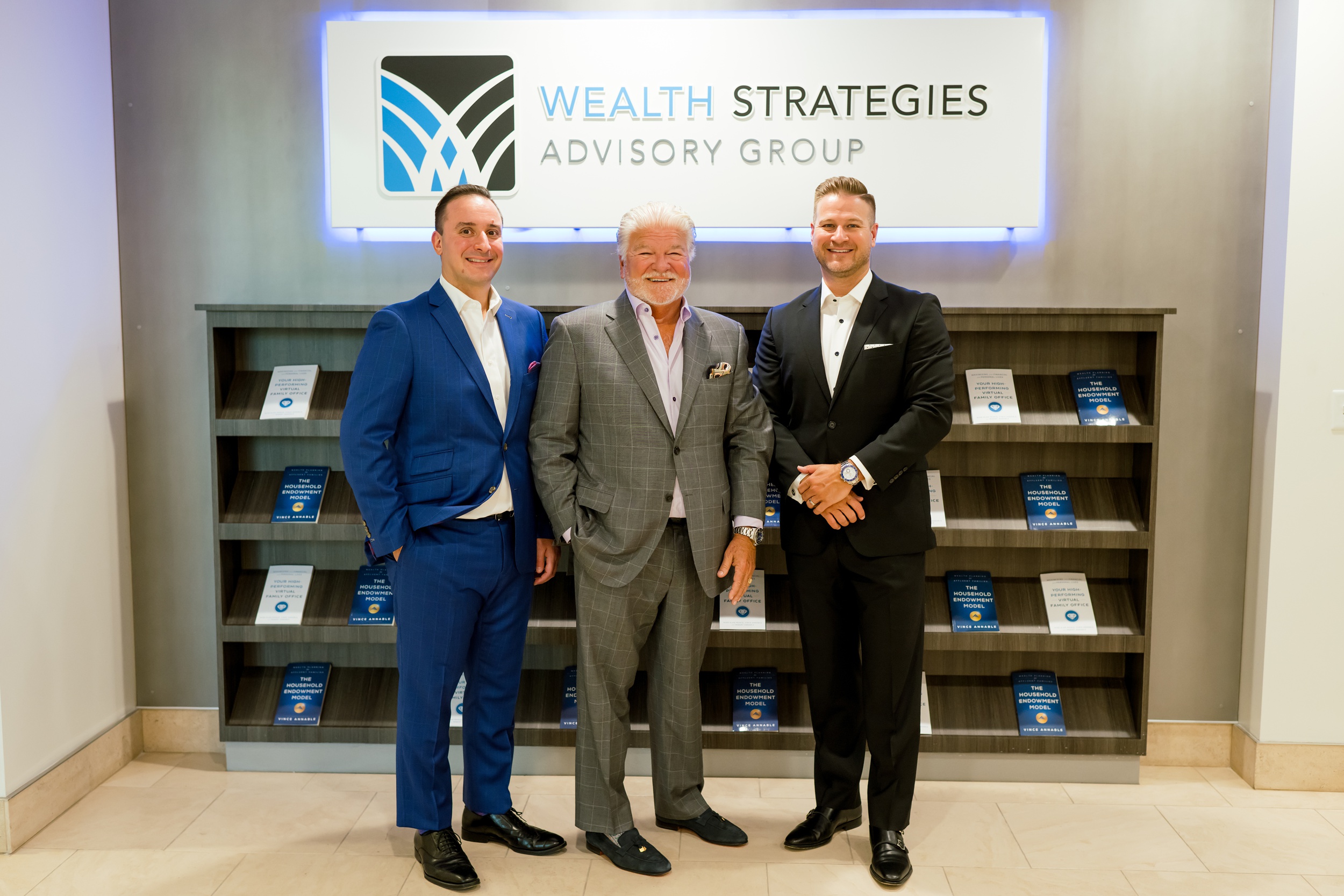 Three businessmen stand under their sign to update brand photos