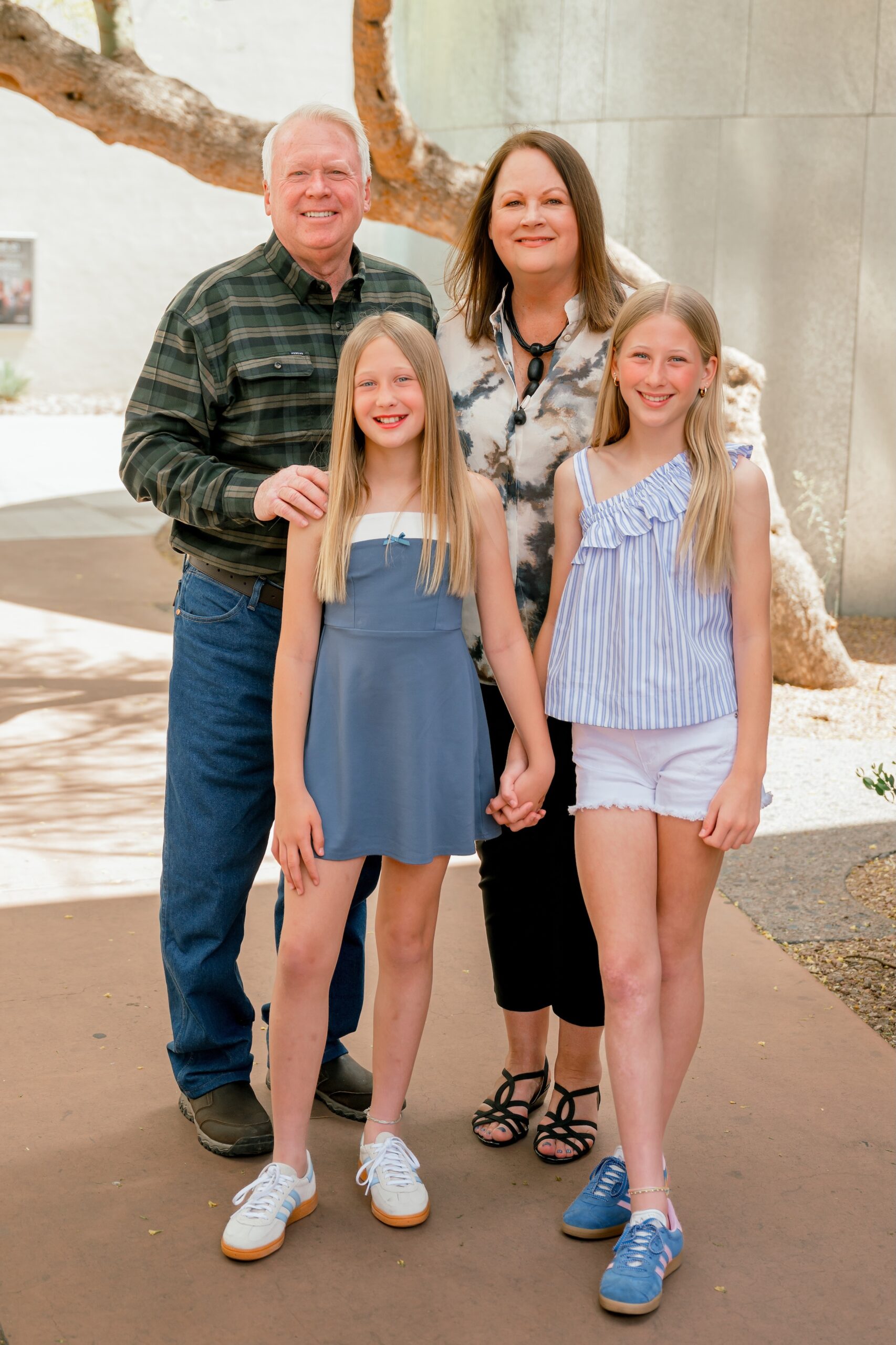 grandparents standing with their grand daughters in old town scottsdale 