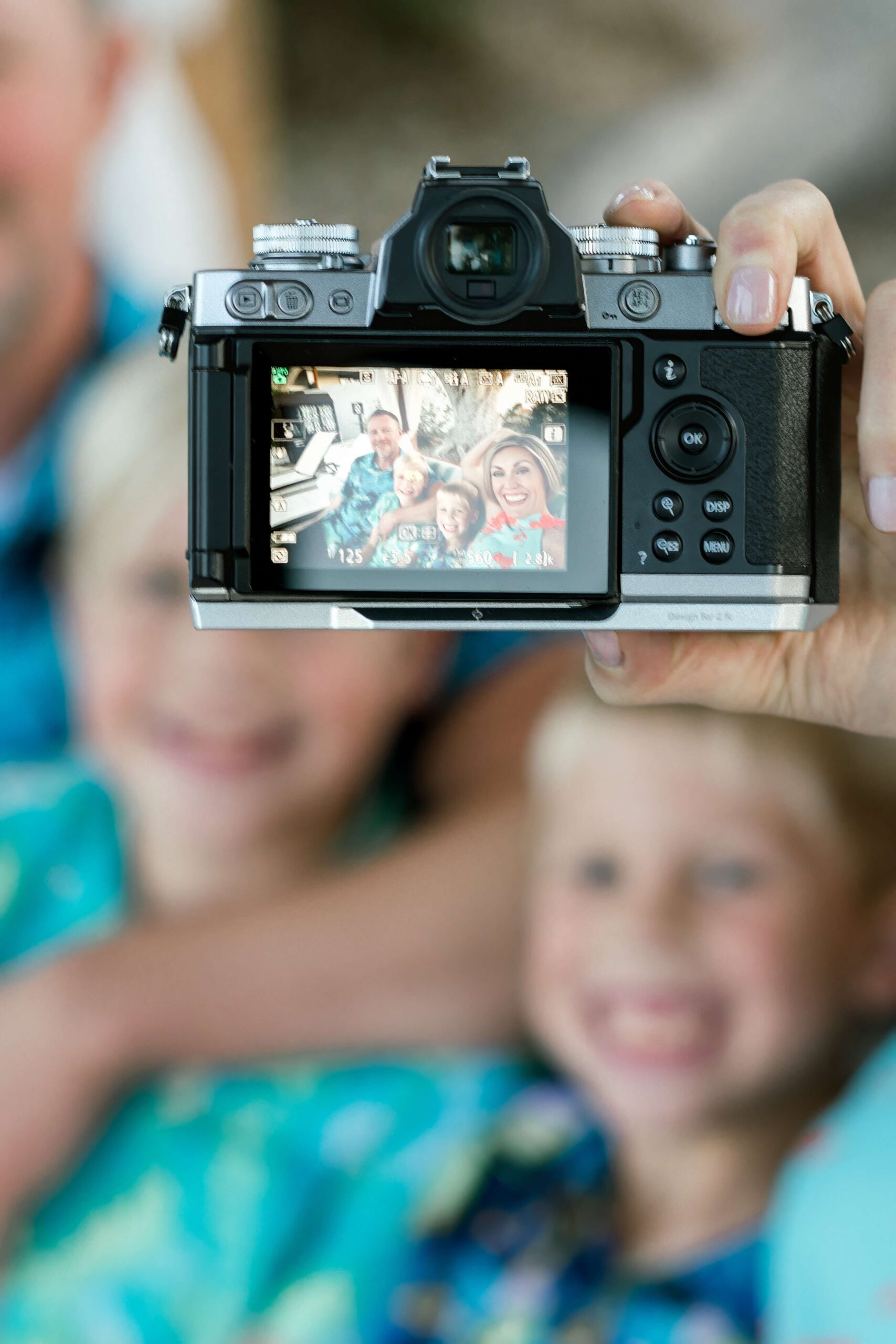 A look through a digital camera of a family taking a selfie