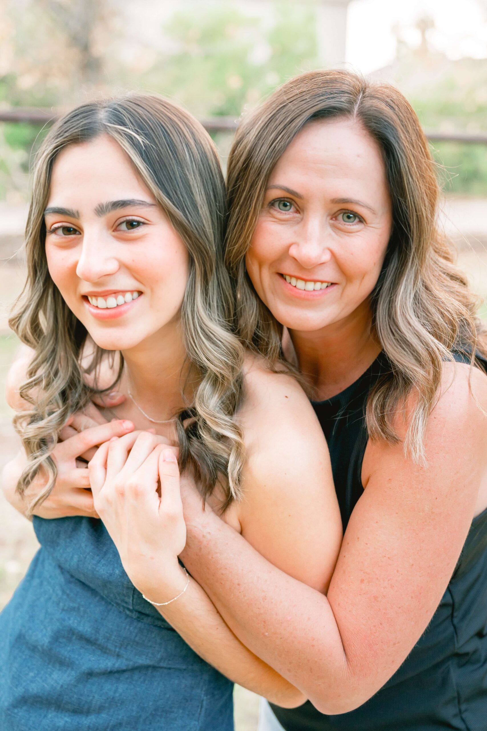 A mom hugs her high school senior in a park after visiting boutiques in phoenix